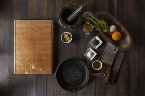 Wooden Cutting board and Grinder for spices on table