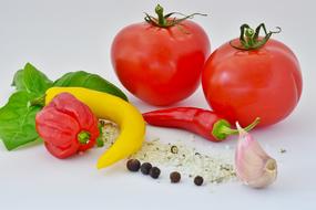 tomatoes, peppers and spices on the table