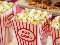 striped boxes with popcorn close-up on blurred background