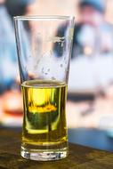 Closeup photo of half a glass of beer on the table