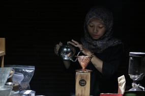 young muslim woman Brewing Coffee