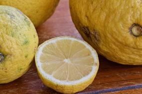 organic lemon on a wooden surface close up