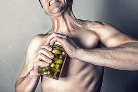 muscular man with a can of pickles