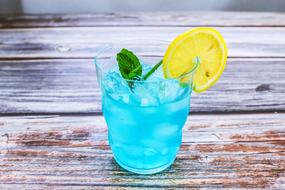 blue lemon cocktail on wooden surface