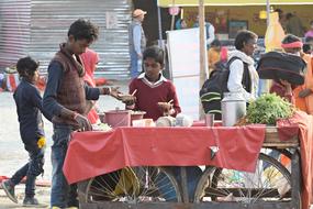 selling cooked foods on a market in India