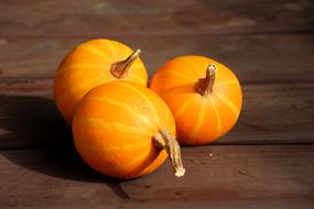 three orange pumpkins