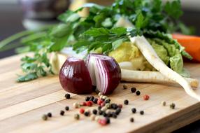 greens, sliced red onions and spices on the table