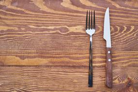 fork and knife on a wooden table