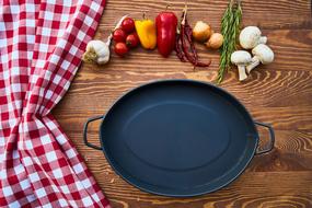 a saucepan next to vegetables on the table