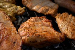 Frying chicken with spices, on the grill