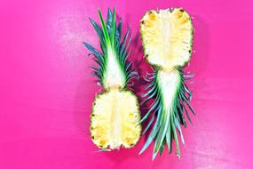 sliced pineapple on a purple background