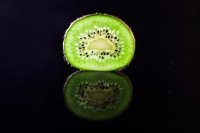 half kiwi on a black background