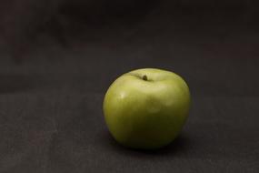 green apple on a dark surface