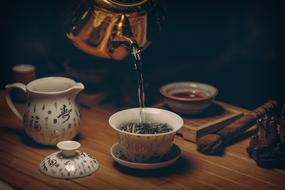 Tea pouring in vintage cup