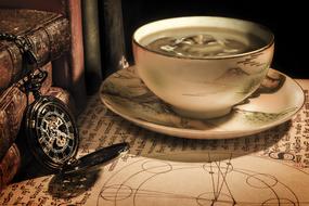 old antique cup with tea on the table