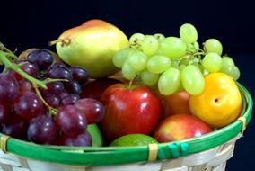 fruits and grapes in a wicker basket