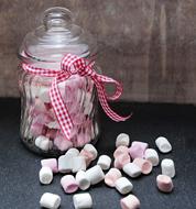 mini Marshmallows in glass jar on table