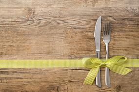 knife and fork on a ribbon as decoration