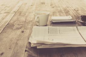 Coffee and newspaper on a wooden table