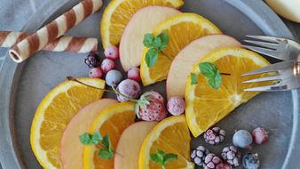 sliced Fruits and berries on plate