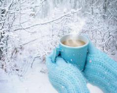 hot drink in the hands of a girl in mittens