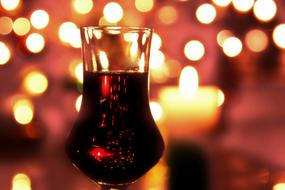red Liqueur in glass at bright background with the lights