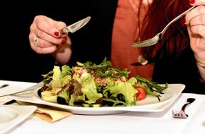 woman eats Salad in Restaurant