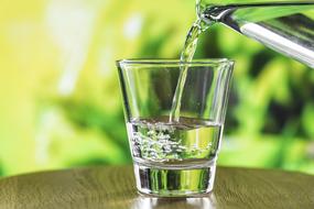 glass with water on a wooden table