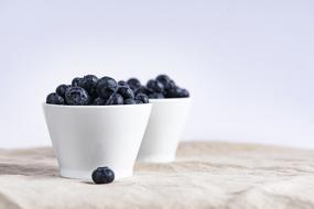 ripe blueberries in white cups