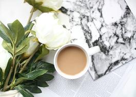 white peonies and coffee with milk on the table