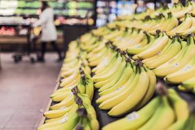 bananas lie in a row on a store counter