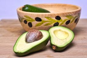 avocado cut on a wooden board