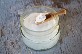 Coconut Oil in jar on Wooden table