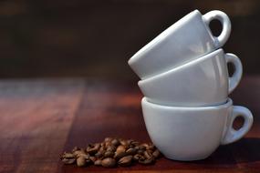 three folded white cups and a handful of coffee