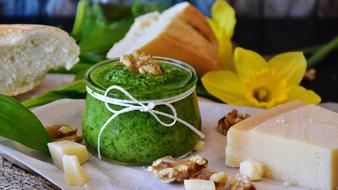 homemade pesto, white bread and cheese on the table