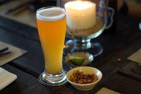 beer and pistachios on a table in a bar