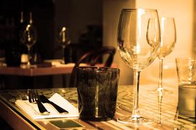 glasses and cutlery on a table in a cafe