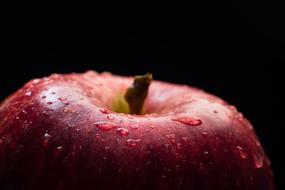 Macro picture of Healthy water drops on a Apple Fruit