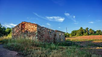 Ruins of the old house among colorful nature
