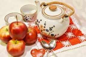 teapot, two cups and apples