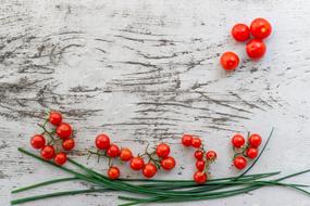 small red Tomatoes at wooden background