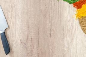 spicies and knife on wooden surface