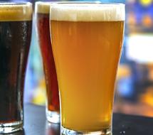 three glasses with different beers in the bar