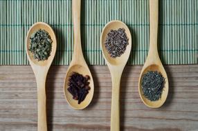 Colorful spices in the wooden spoons