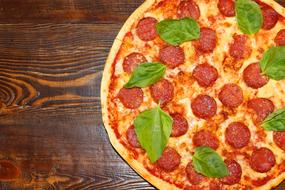Pizza on wooden Table, top view