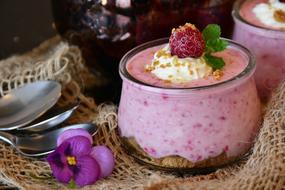 Beautiful raspberry dessert with quark served with spoons