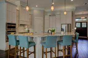 blue bar stools in a modern kitchen-living room