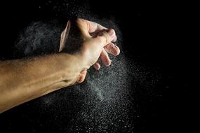 Closeup picture of sprinkle flour in the dark