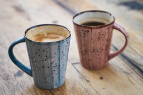 two mugs with Coffee on wooden table