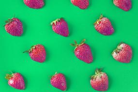 photo of ripe strawberries on a green field